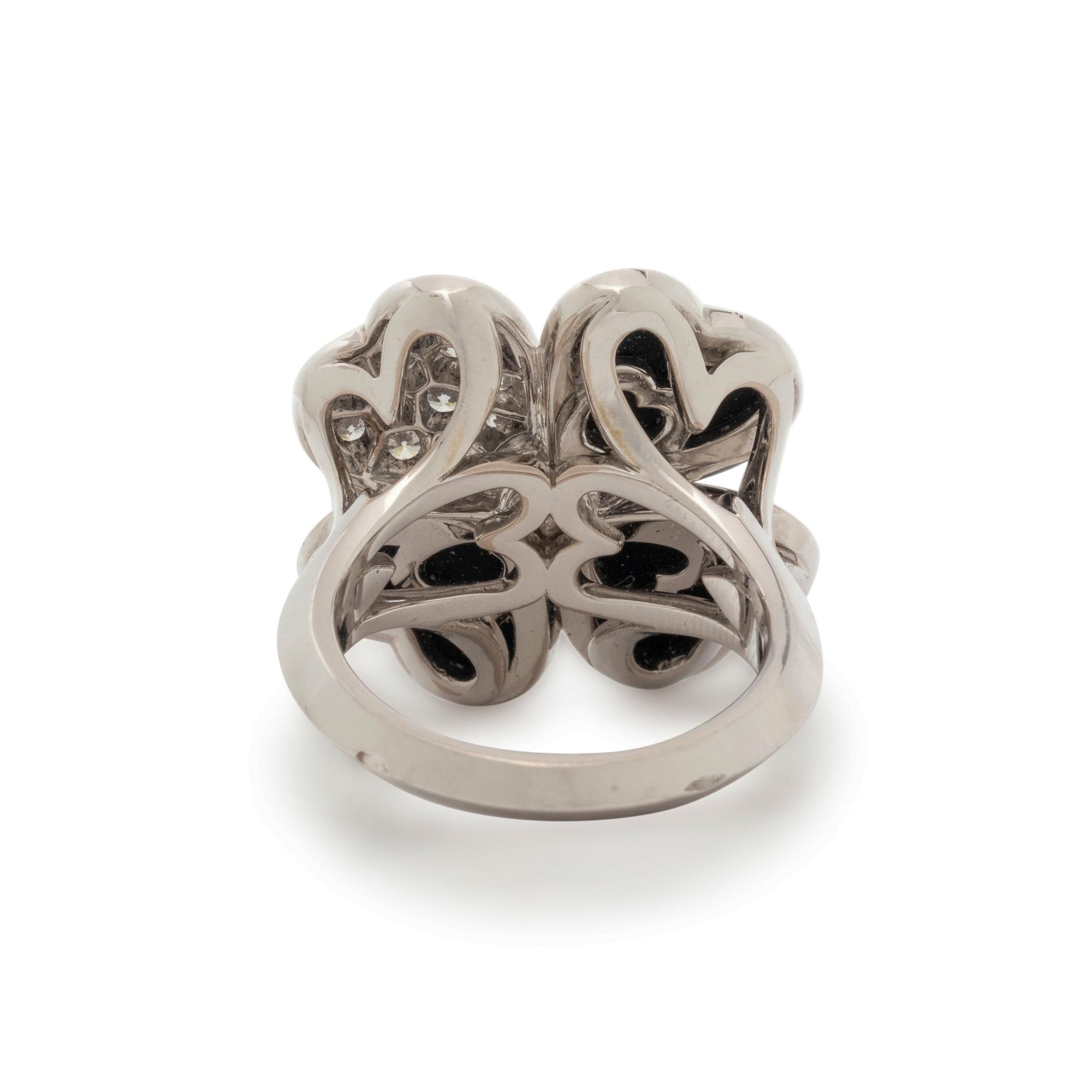 VAN CLEEF & ARPELS, DIAMOND, ONYX AND WHITE GOLD 'COSMOS' RING