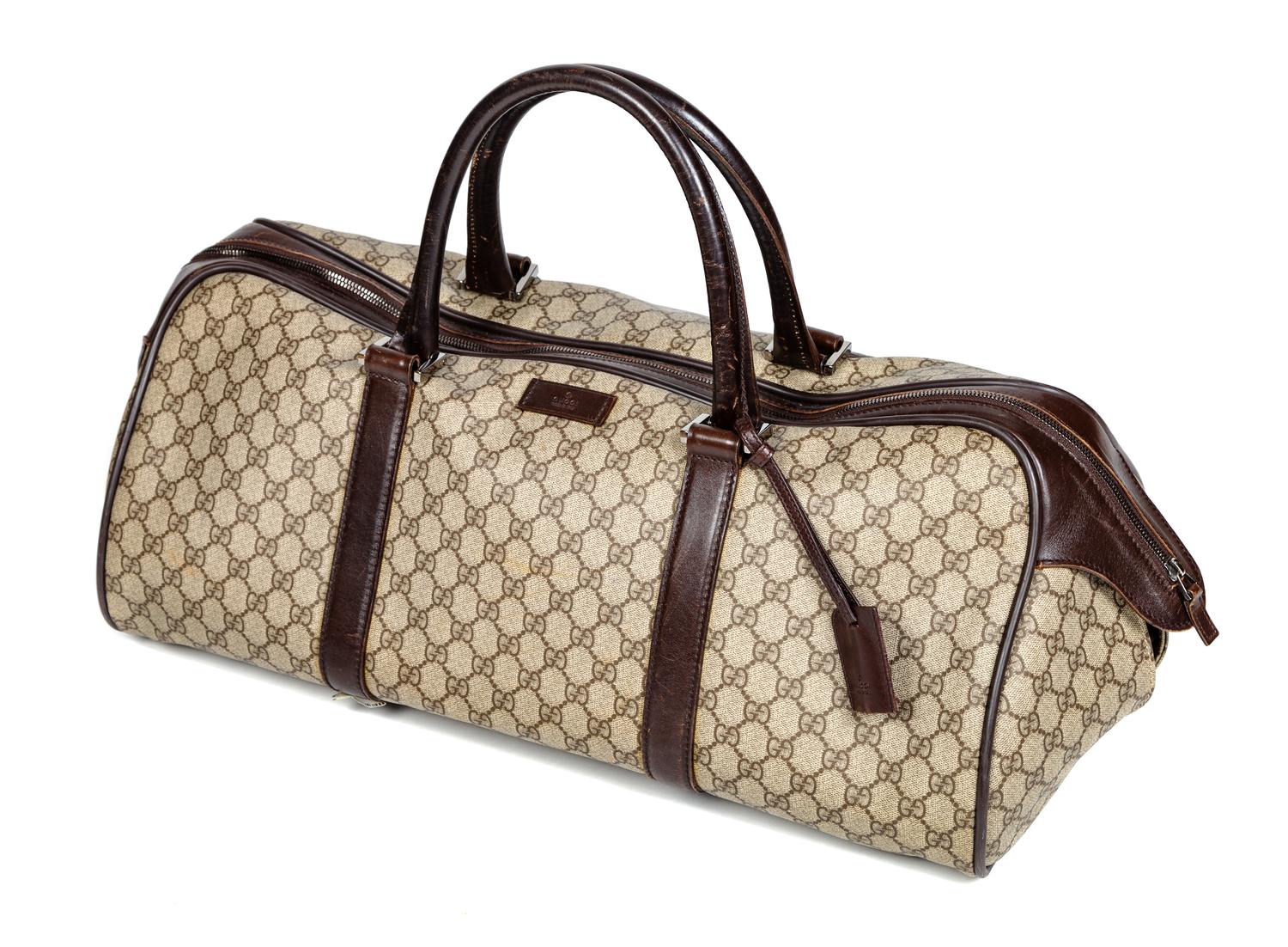 A Gucci Monogram Canvas Duffle Bag, 9.5" H x 21.5" W x 10.5" D; Handle drop: 6".
