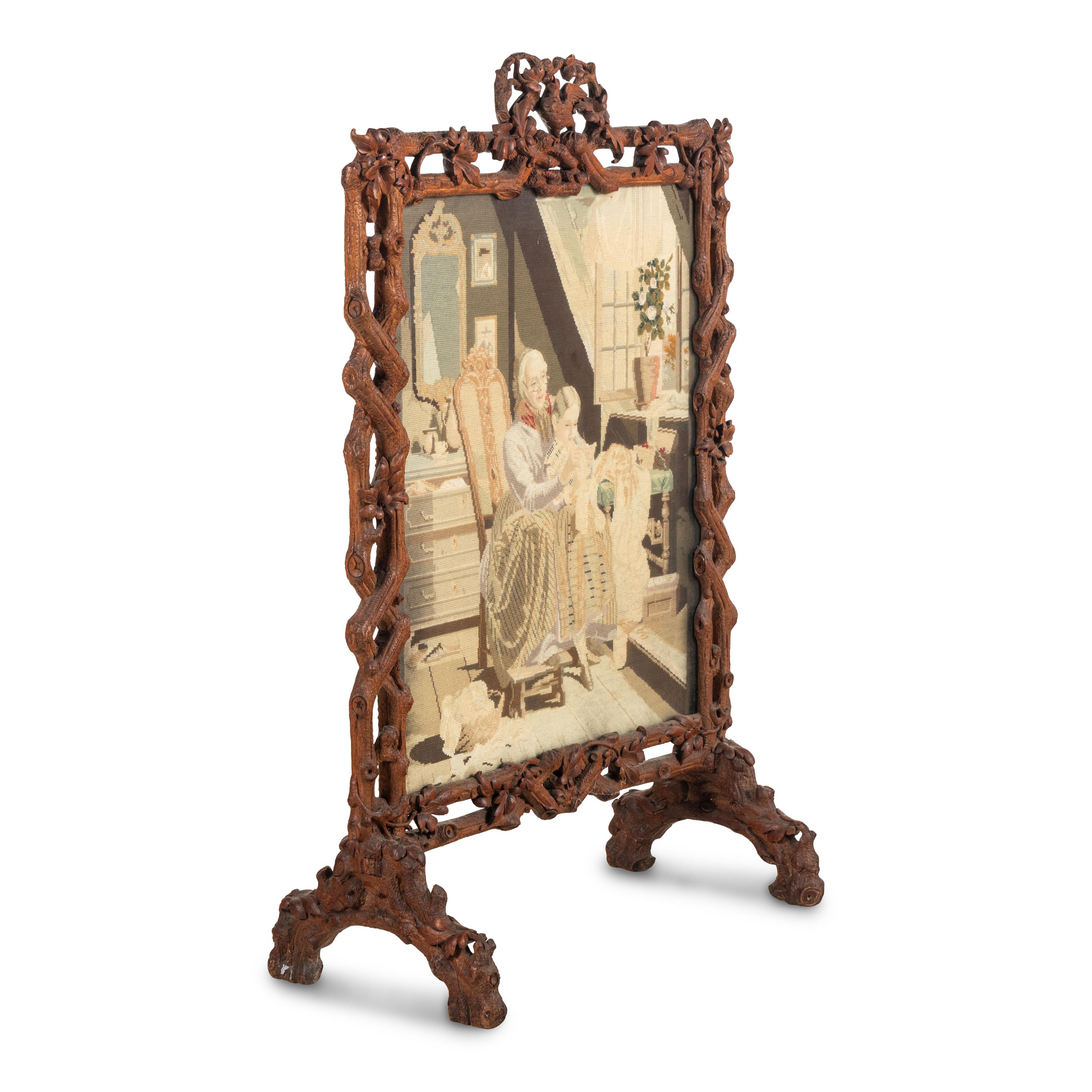 A Swiss "Black Forest" Carved Needlepoint-Inset Firescreen