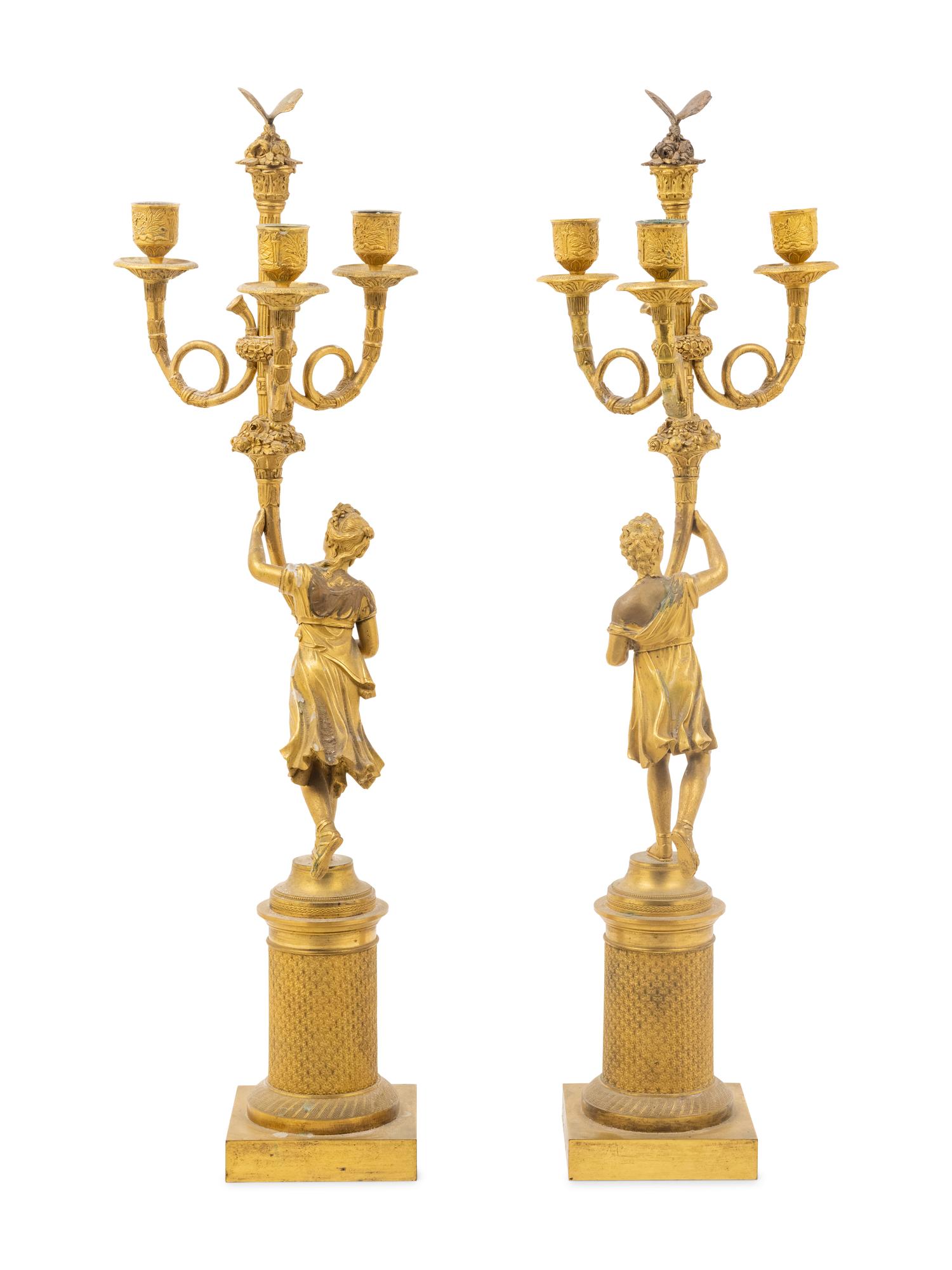 A Pair of French Gilt Bronze Figural Three-Light Candelabra