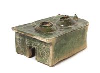 A Chinese Dark Green Glazed Pottery Model of a Stove Length 9 x width 6 3/4 inches. — HAN DYNASTY (206 B.C. - A.D. 220)