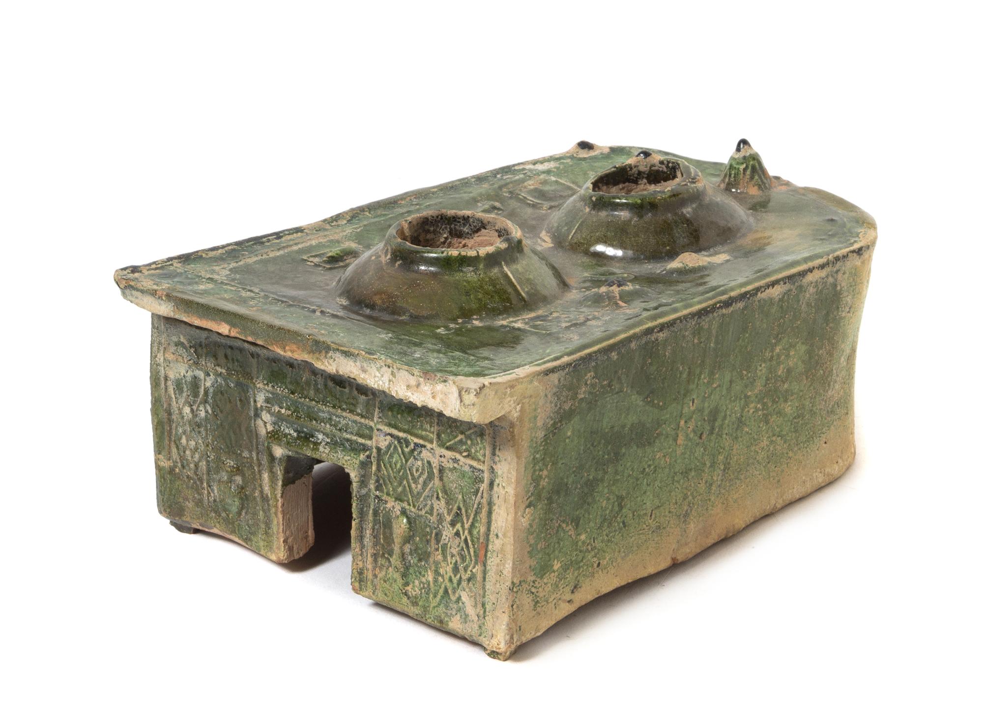 A Chinese Dark Green Glazed Pottery Model of a Stove Length 9 x width 6 3/4 inches. — HAN DYNASTY (206 B.C. - A.D. 220)