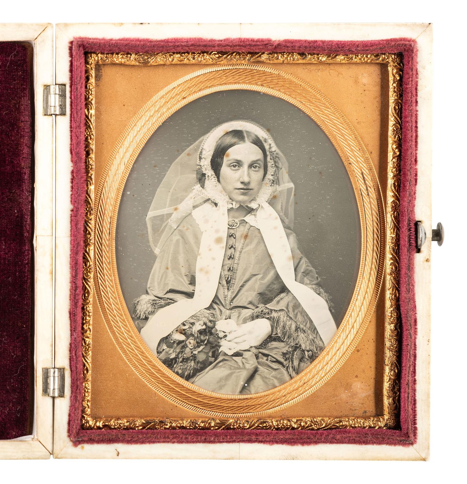 [EARLY PHOTOGRAPHY]. Striking daguerreotype portrait of a young woman wearing a veil.