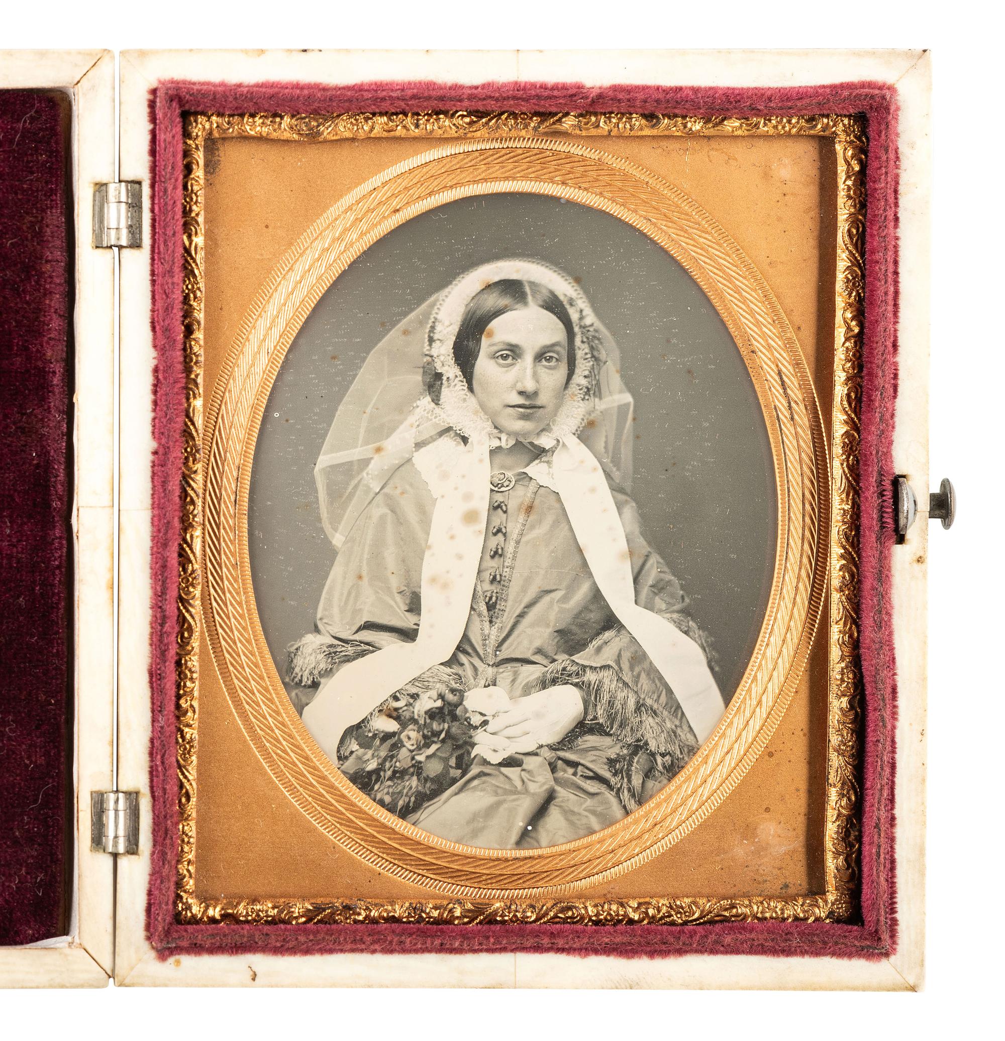 [EARLY PHOTOGRAPHY]. Striking daguerreotype portrait of a young woman wearing a veil.