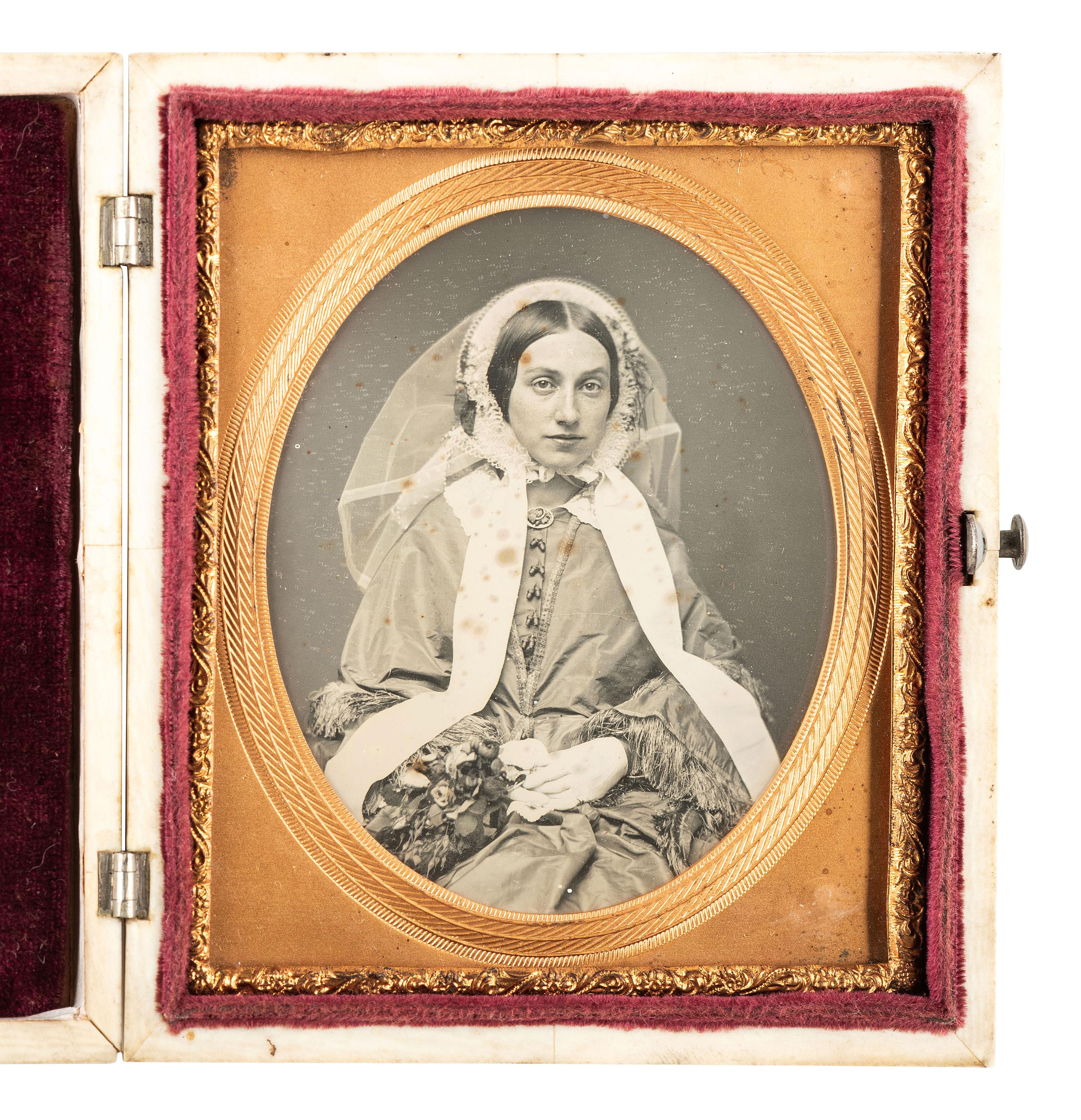 [EARLY PHOTOGRAPHY]. Striking daguerreotype portrait of a young woman wearing a veil.