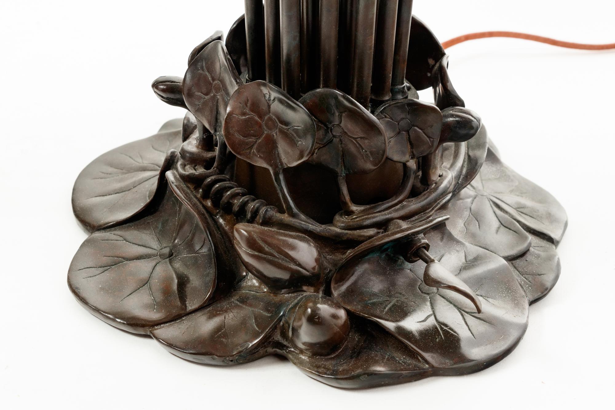 A Pair of Art Nouveau Style Patinated Metal and Iridescent Glass Eighteen-Light Tulip Lamps