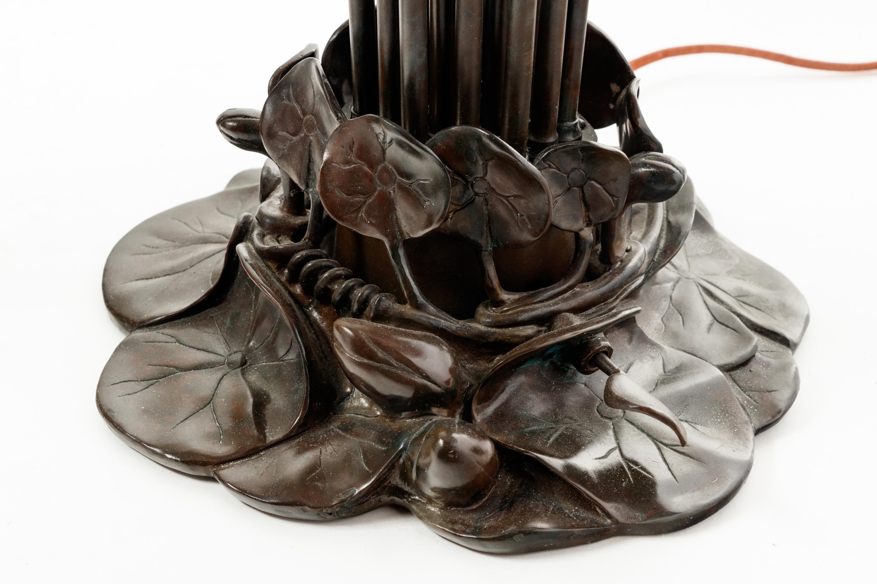 A Pair of Art Nouveau Style Patinated Metal and Iridescent Glass Eighteen-Light Tulip Lamps