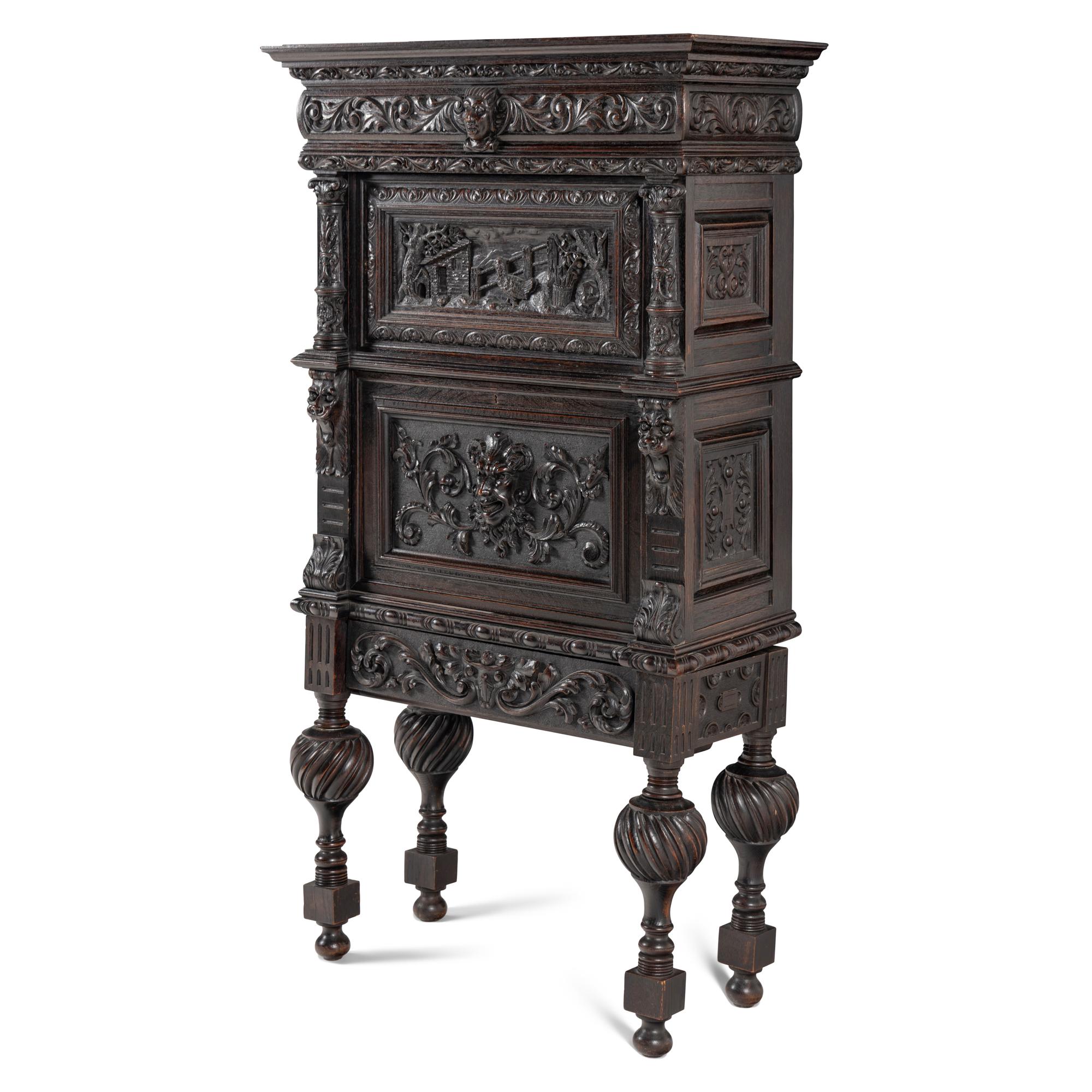 An Italian Renaissance Revival Carved Oak Bureau Cabinet on Stand