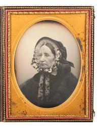 [EARLY PHOTOGRAPHY]. WARREN, George K., artist. Half plate daguerreotype of a well-dressed matron, from the personal studio collection of Warren. Lowell, MA, ca 1858-1864.