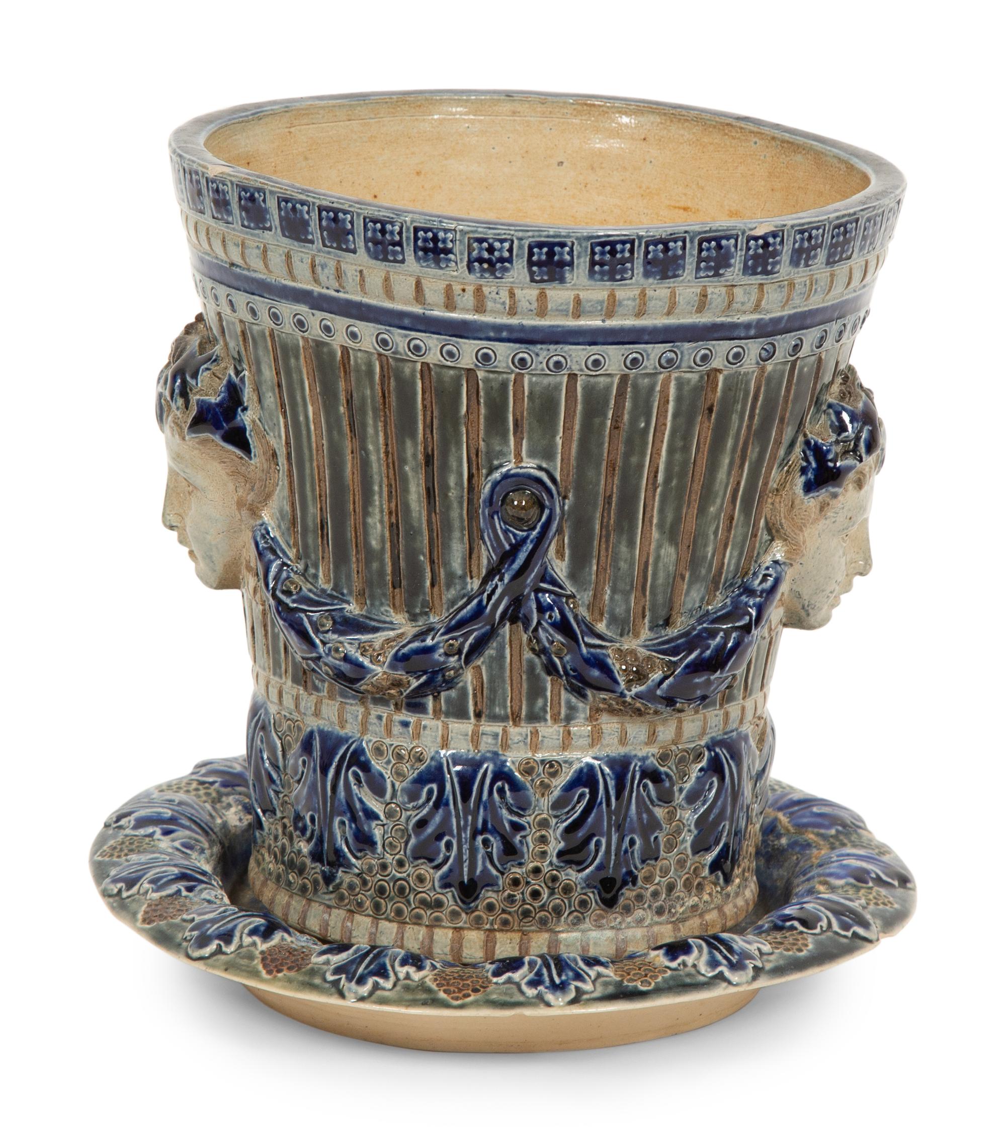 An English Majolica Jardiniere with Stand and a Cistern-form Wall Pocket