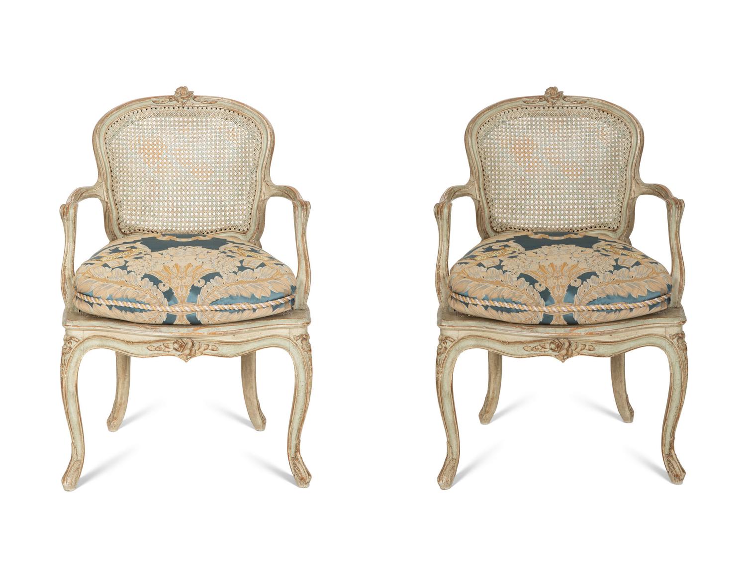 A Pair of Louis XV Blue Painted Cane-Backed Fauteuils