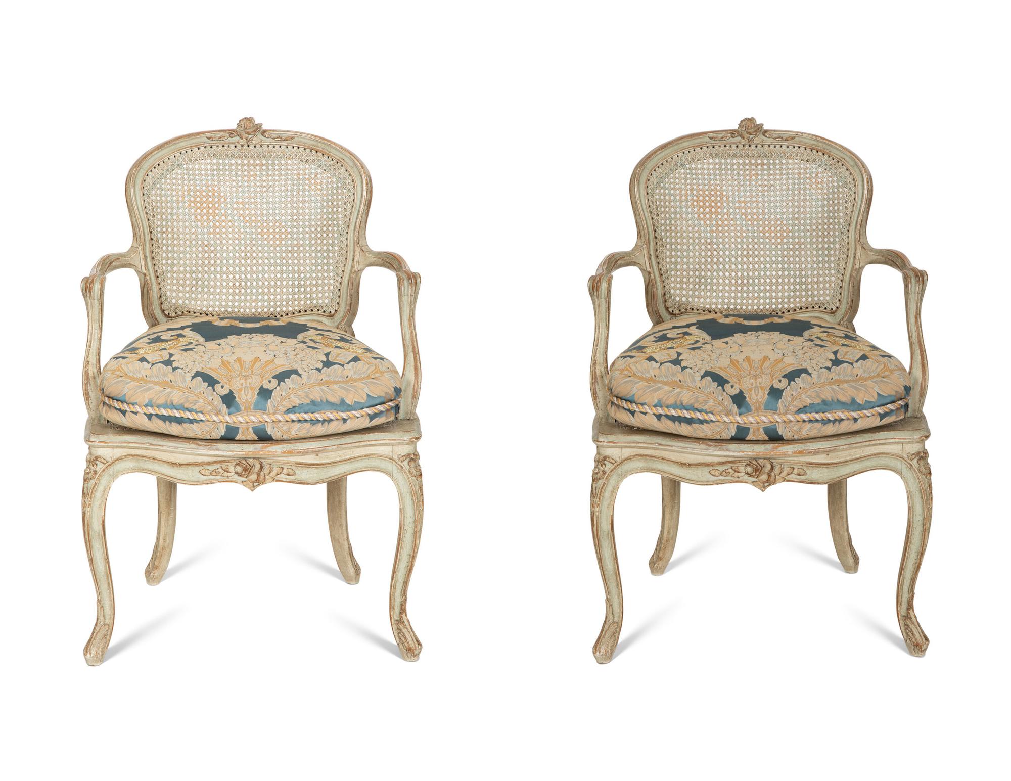 A Pair of Louis XV Blue Painted Cane-Backed Fauteuils