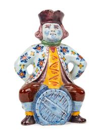 A Faïence "Man on a Barrel" Character Jug