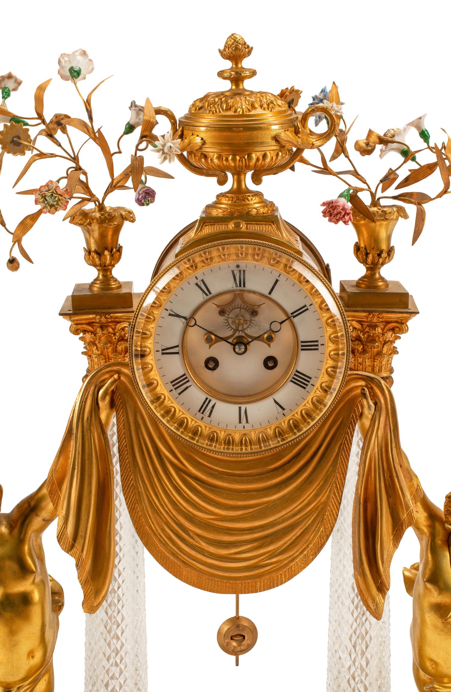A Louis XV Style Gilt Bronze, Porcelain and Cut Glass Clock Garniture
