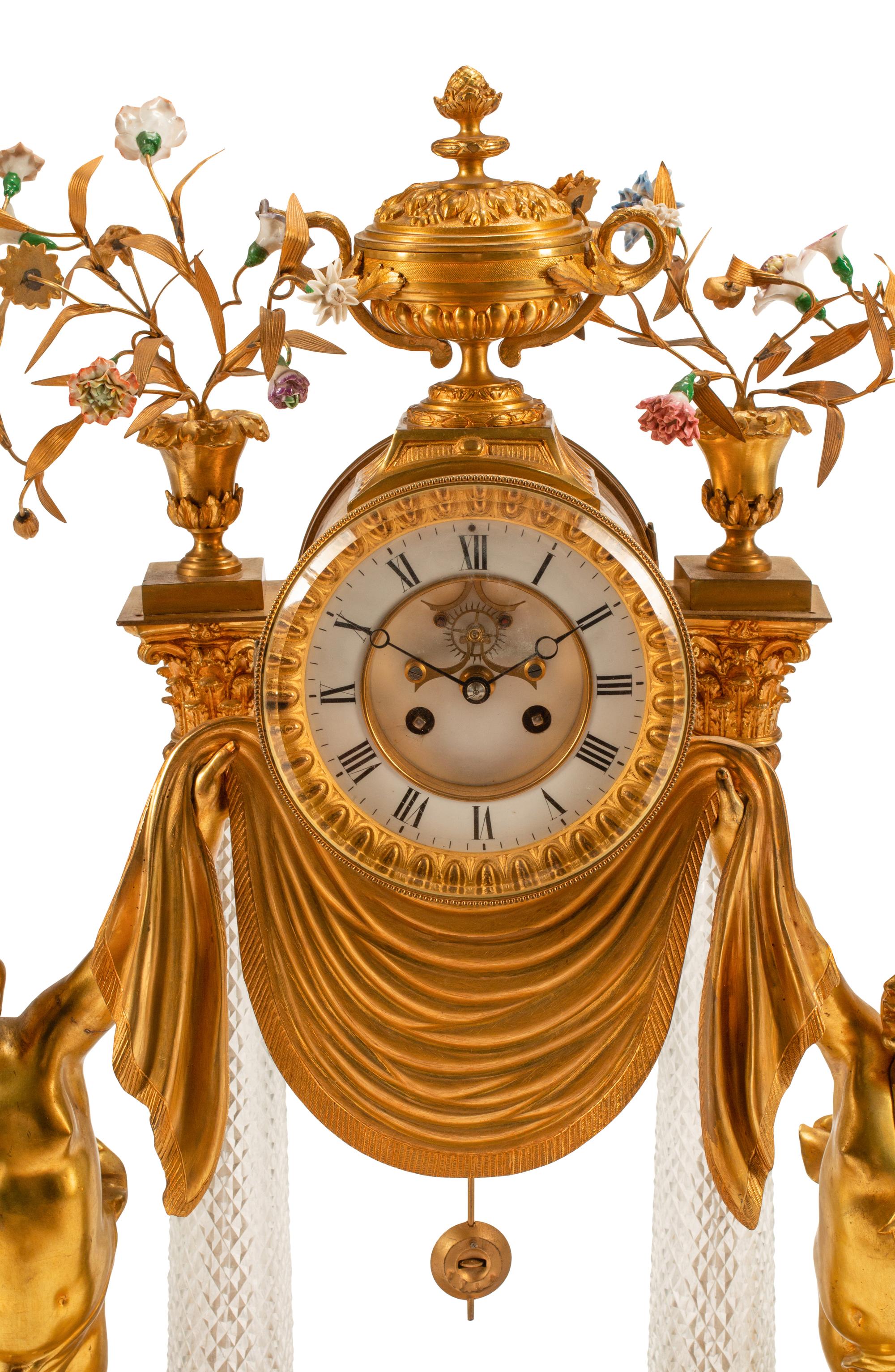 A Louis XV Style Gilt Bronze, Porcelain and Cut Glass Clock Garniture