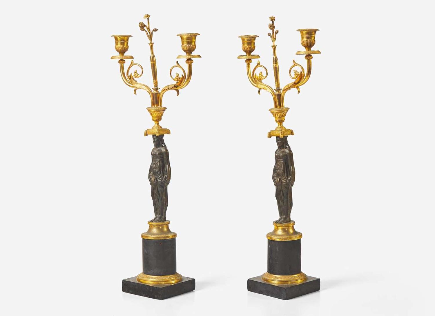 A pair of French Empire gilt and patinated bronze candelabras, first quarter 19th century