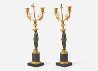 A pair of French Empire gilt and patinated bronze candelabras, first quarter 19th century