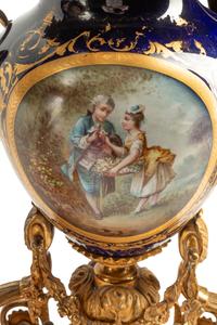 A French Gilt Bronze and Sèvres Style Porcelain Clock Garniture