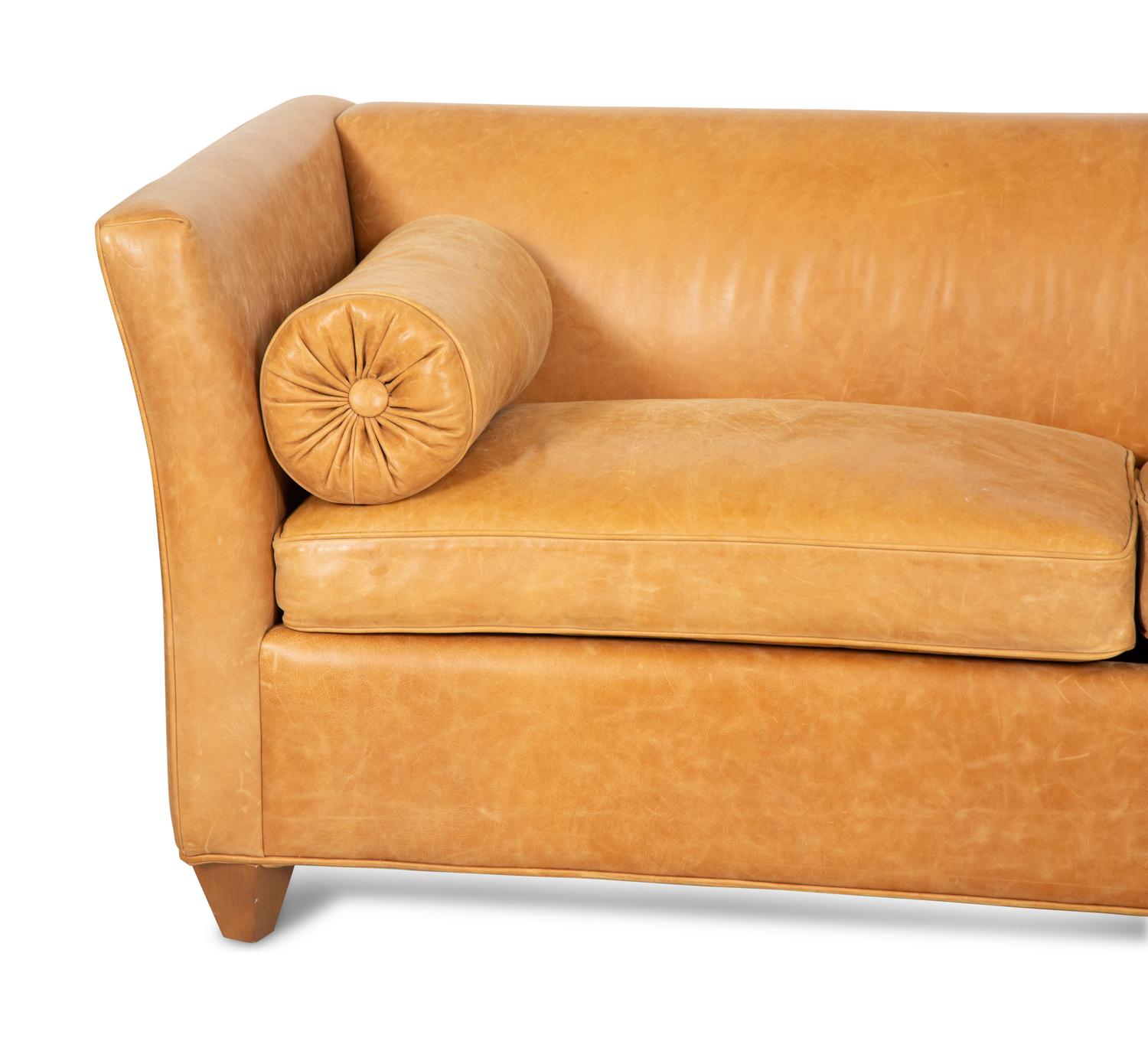 A Contemporary Leather Sofa with Two Bolster Pillows