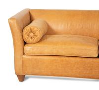 A Contemporary Leather Sofa with Two Bolster Pillows