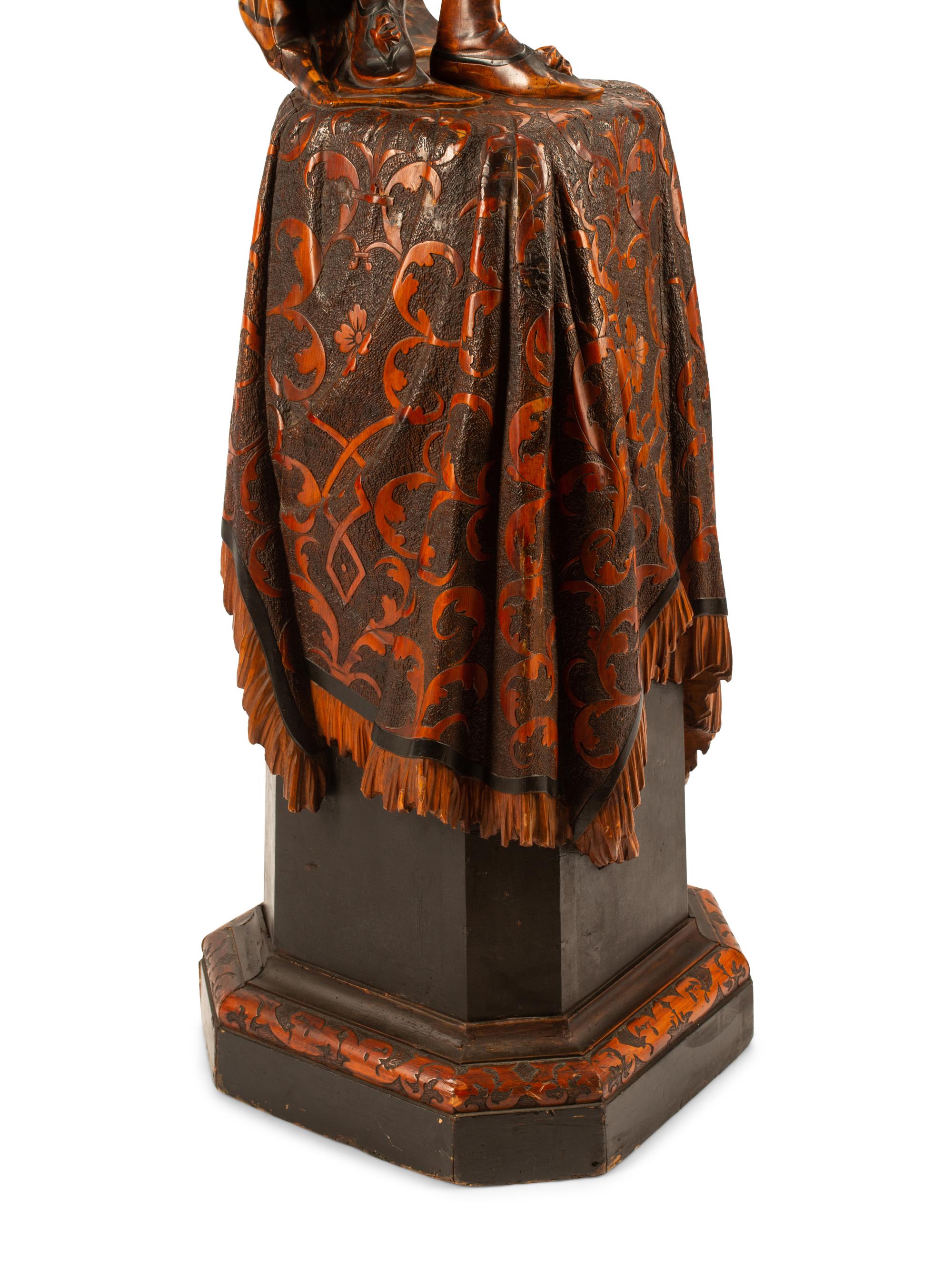 An Austrian Carved Wood Figural Torchere