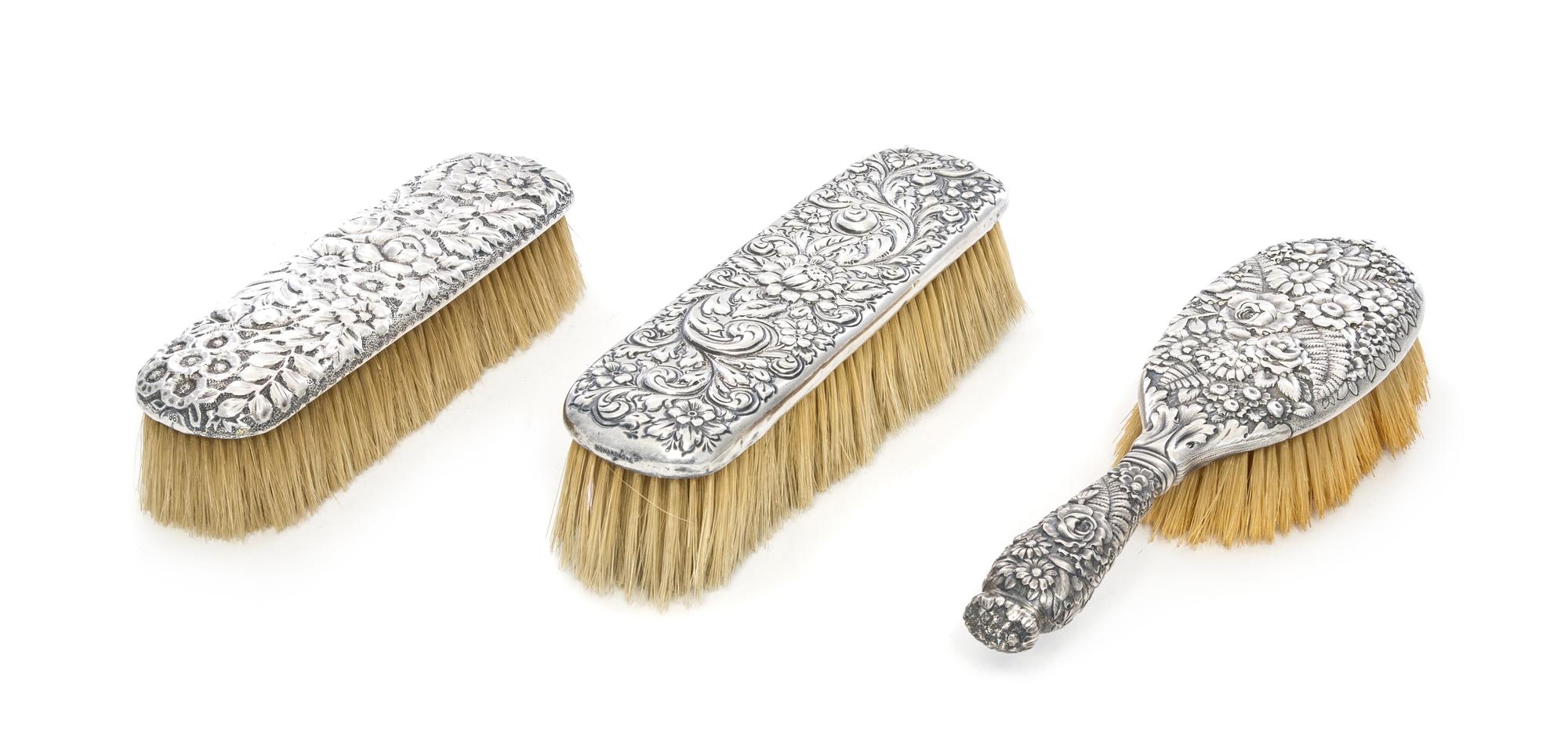 Three American Silver Brushes, Various Makers, comprising a Tiffany & Co. Repousse hairbrush, together with a similarly decorated Gorha
