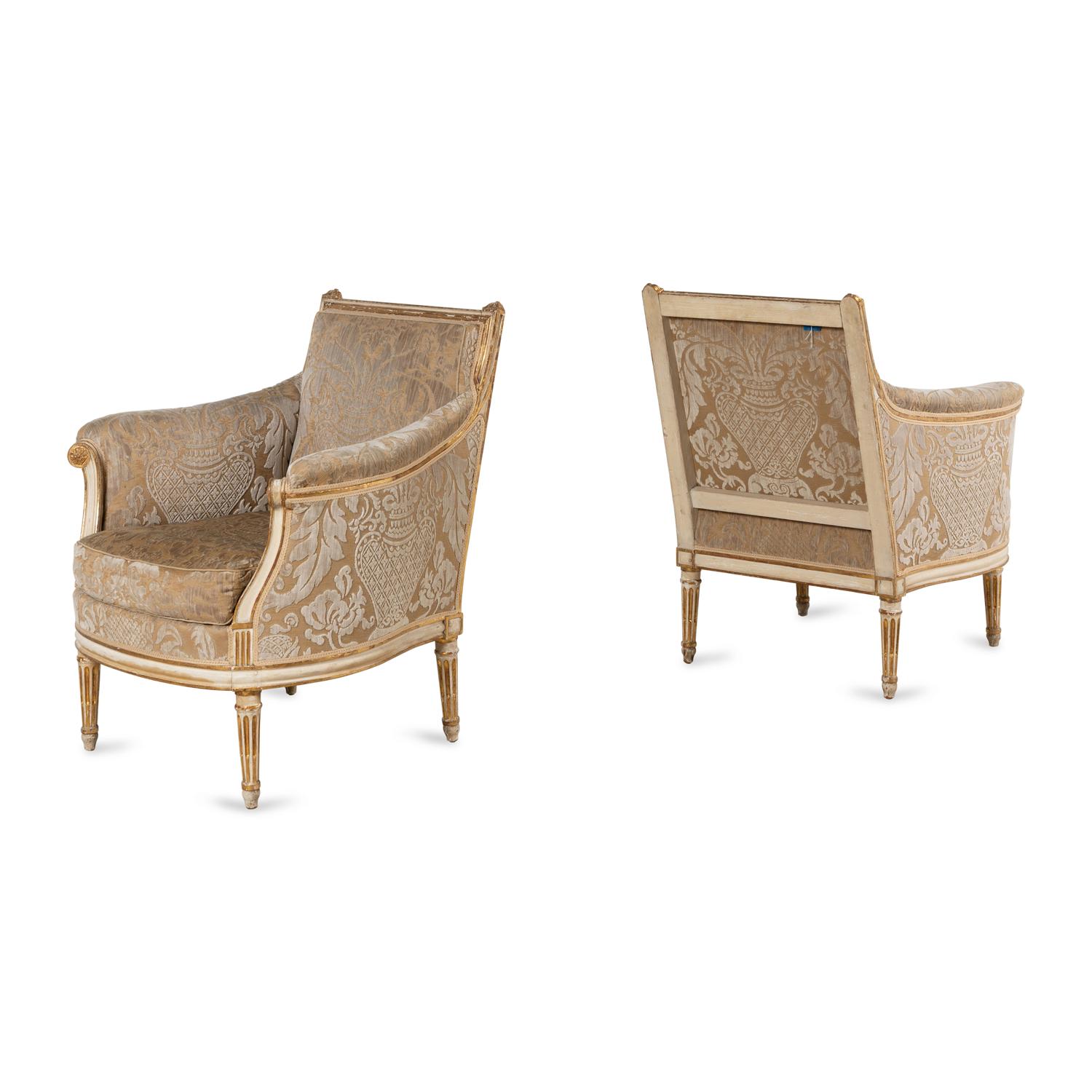 A Pair of Louis XVI Cream-Painted and Parcel Gilt Bergères