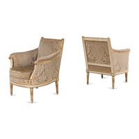 A Pair of Louis XVI Cream-Painted and Parcel Gilt Bergères