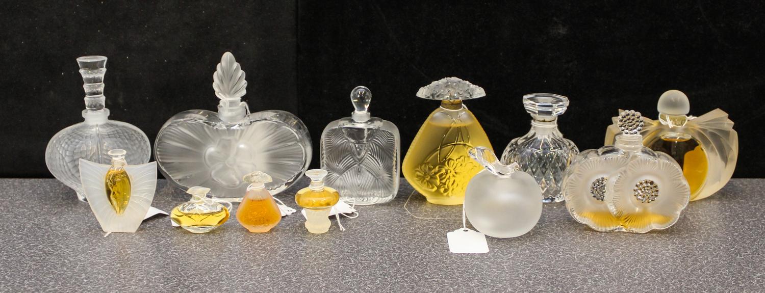 A Group of Twelve Lalique Glass Perfume Bottles Height of tallest 4 3/4 inches.