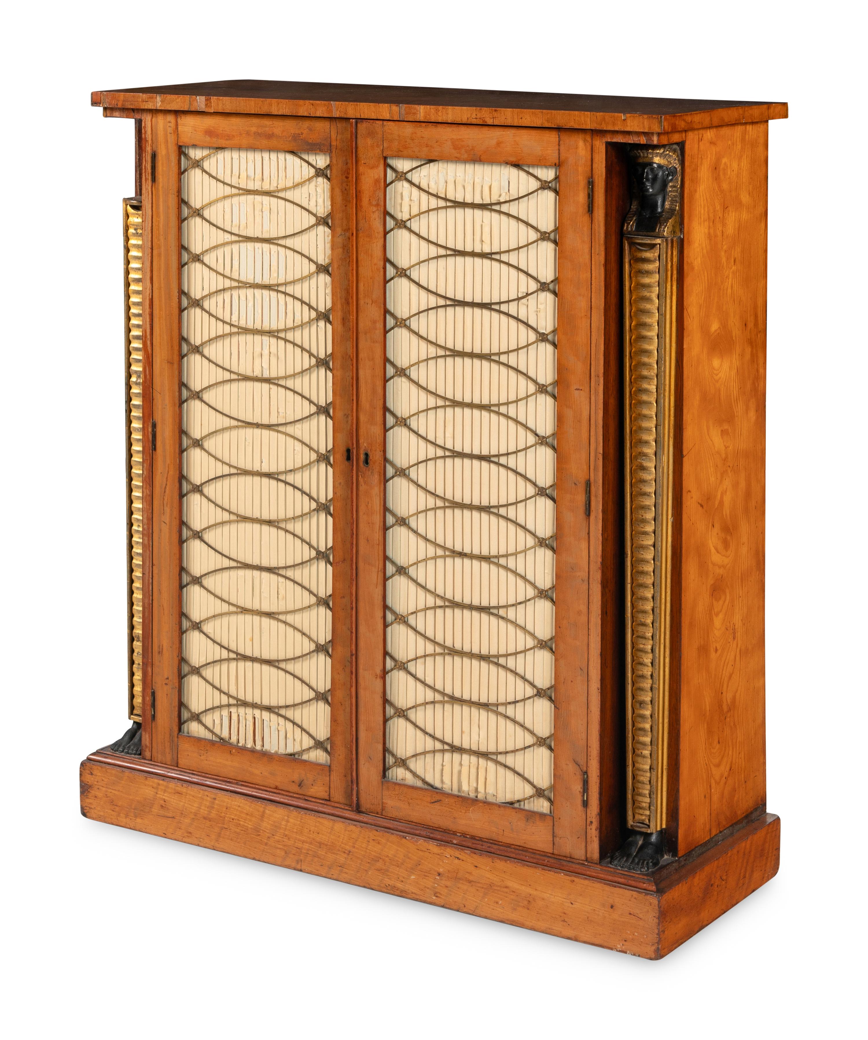 A Regency Satinwood, Part Ebonized and Parcel Gilt Cabinet