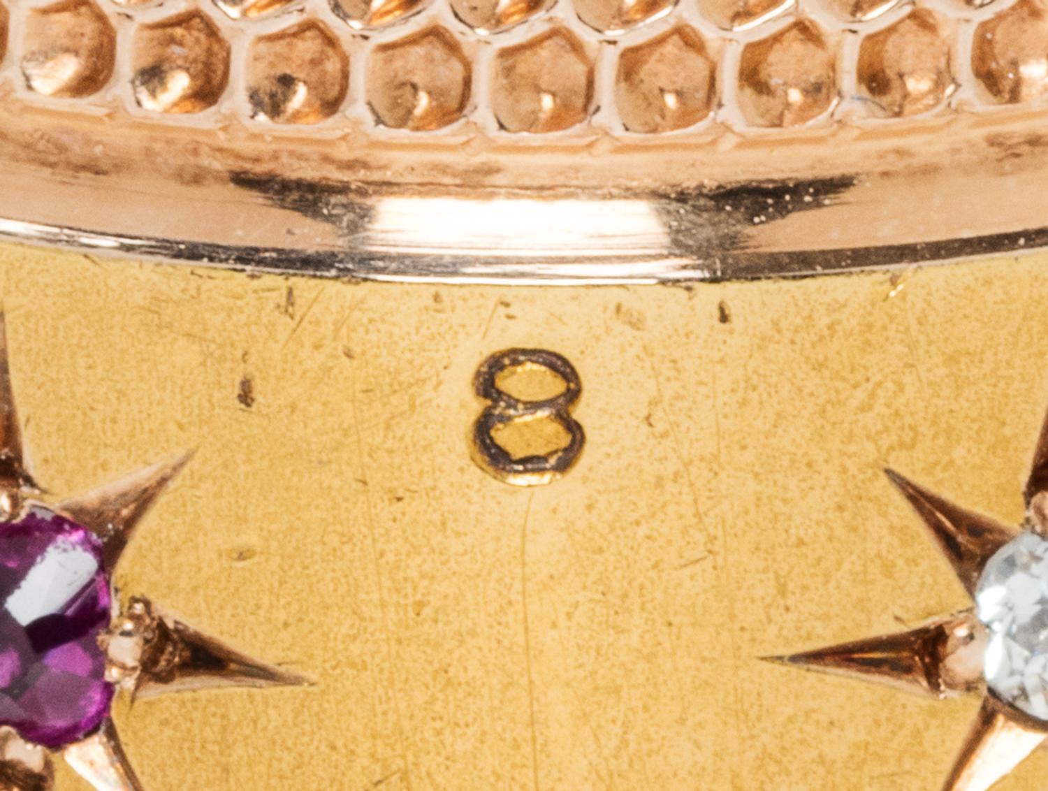 An American 14-Karat Yellow Gold, Diamond and Ruby Thimble, Simons Brothers Co., Philadelphia, PA, the knurled top and body above a pla