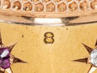 An American 14-Karat Yellow Gold, Diamond and Ruby Thimble, Simons Brothers Co., Philadelphia, PA, the knurled top and body above a pla