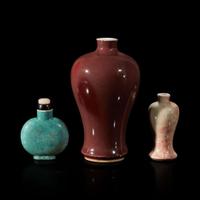 A Chinese red-glazed small meiping and two porcelain snuff bottles