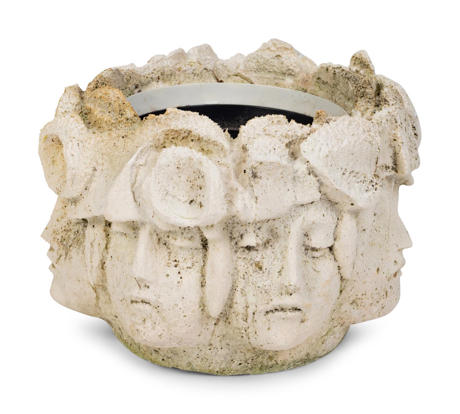 A Cast Concrete Jardinière with Faces in Relief