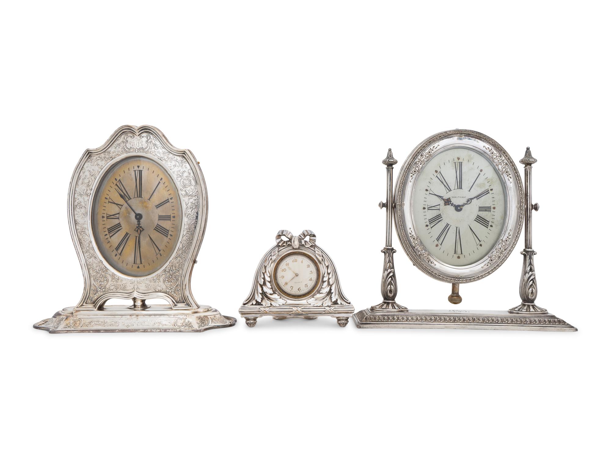 A Collection of Three Silver Desk Clocks