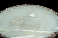 A Chinese Silvered Metal Mounted Carved White Jade 'Caparisoned Elephant' Plaque