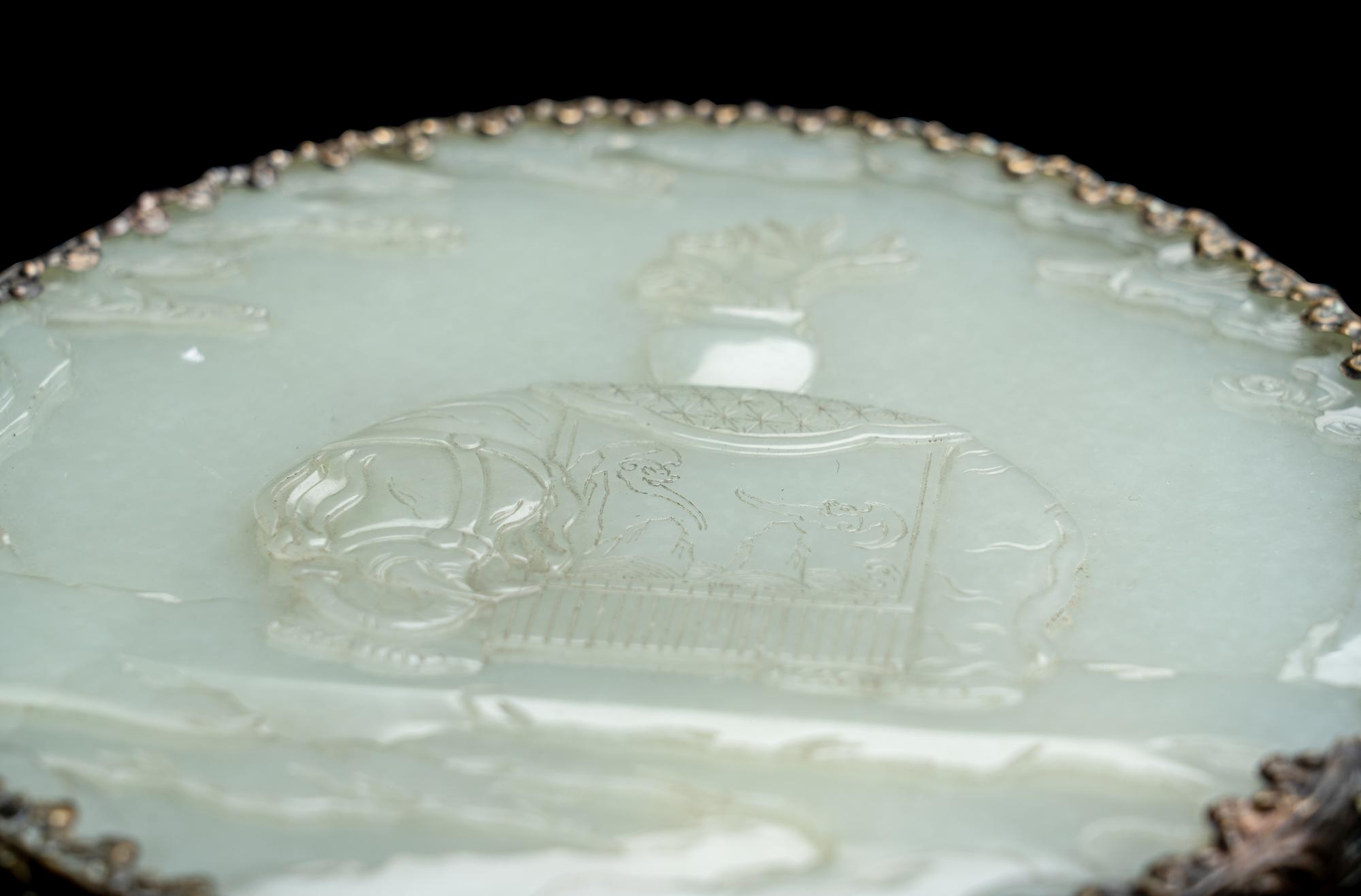A Chinese Silvered Metal Mounted Carved White Jade 'Caparisoned Elephant' Plaque