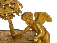 A French Empire L'Amour Jardinier Gilt Bronze Mantel Clock