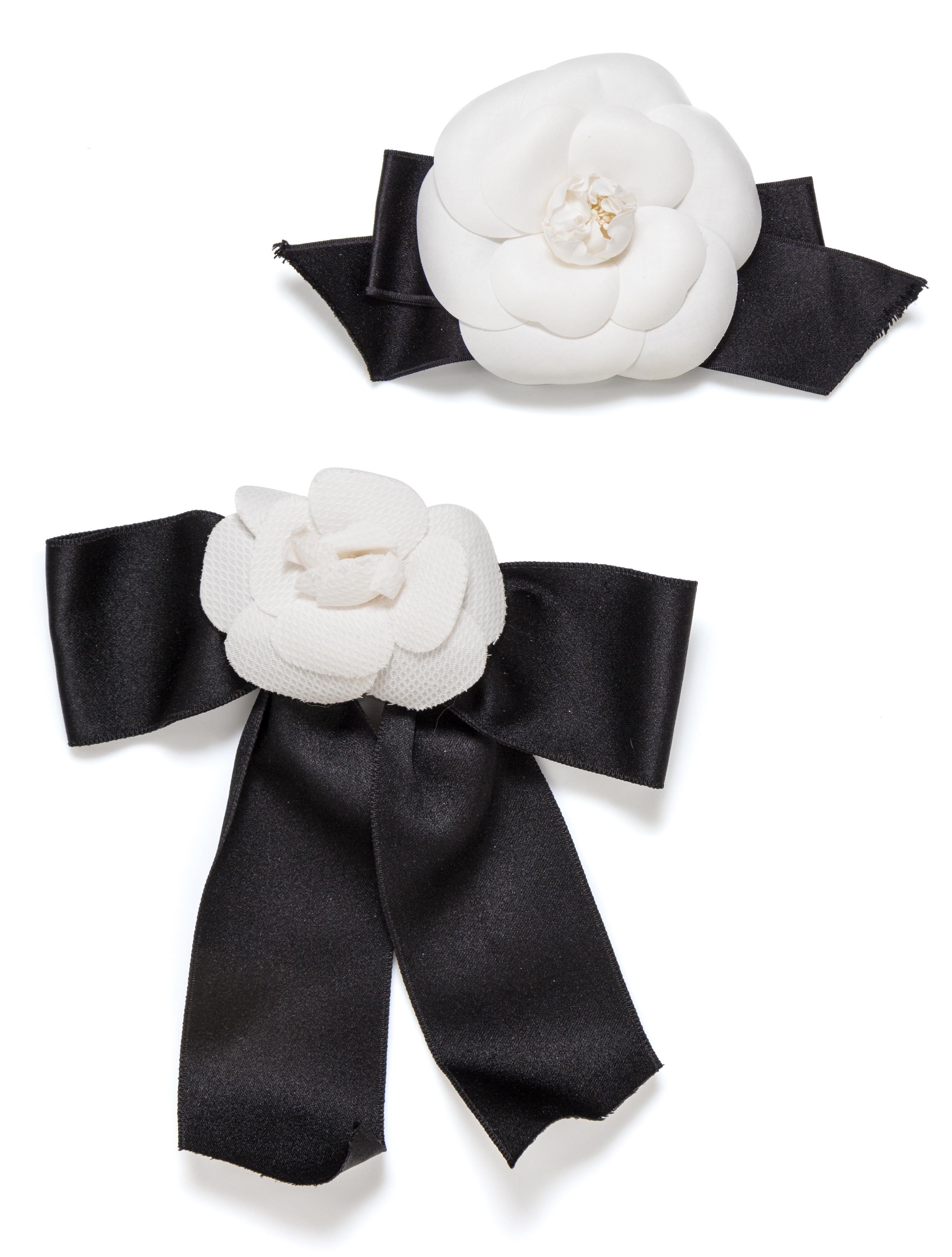 A Pair of Chanel White Camelia and Satin Ribbon Pins, 7.5" x 4", 9" x 7.5".