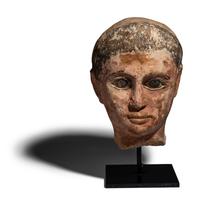 An Egyptian Painted Limestone Head of a Youth