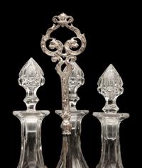 An English Silver-Plate Tantalus with Three Cut Glass Decanters