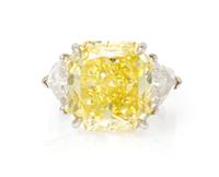 A Fine Platinum, Fancy Intense Yellow Diamond and Diamond Ring, 7.40 dwts.