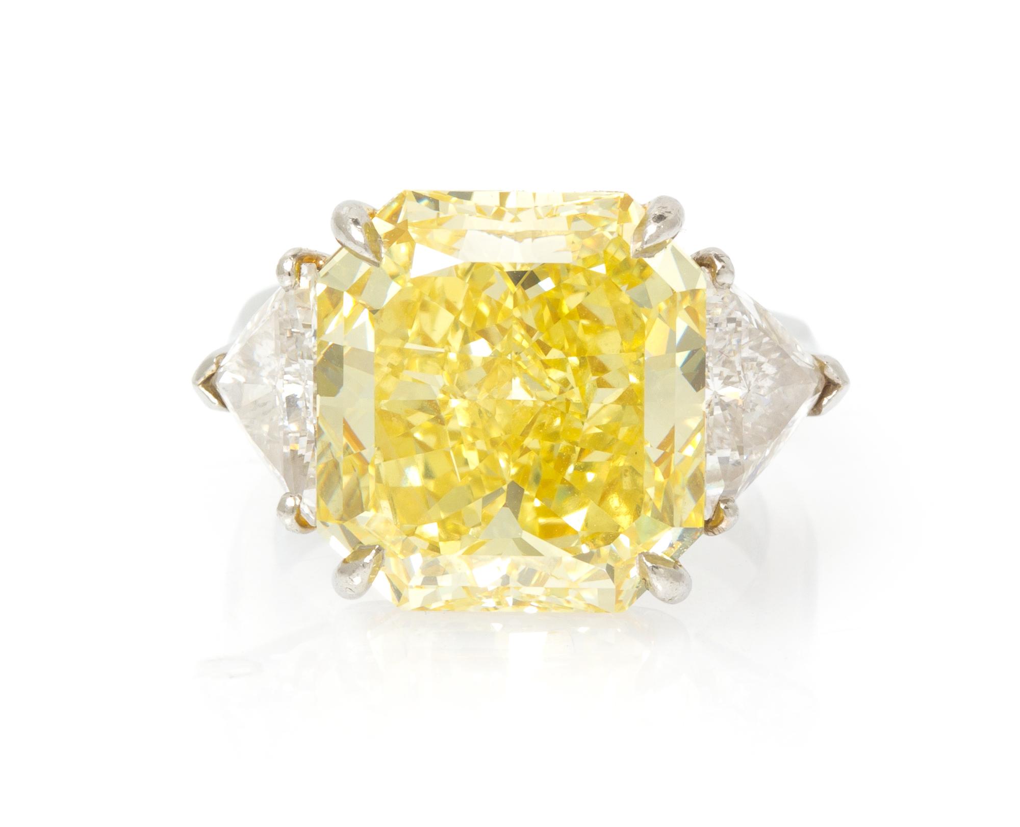 A Fine Platinum, Fancy Intense Yellow Diamond and Diamond Ring, 7.40 dwts.