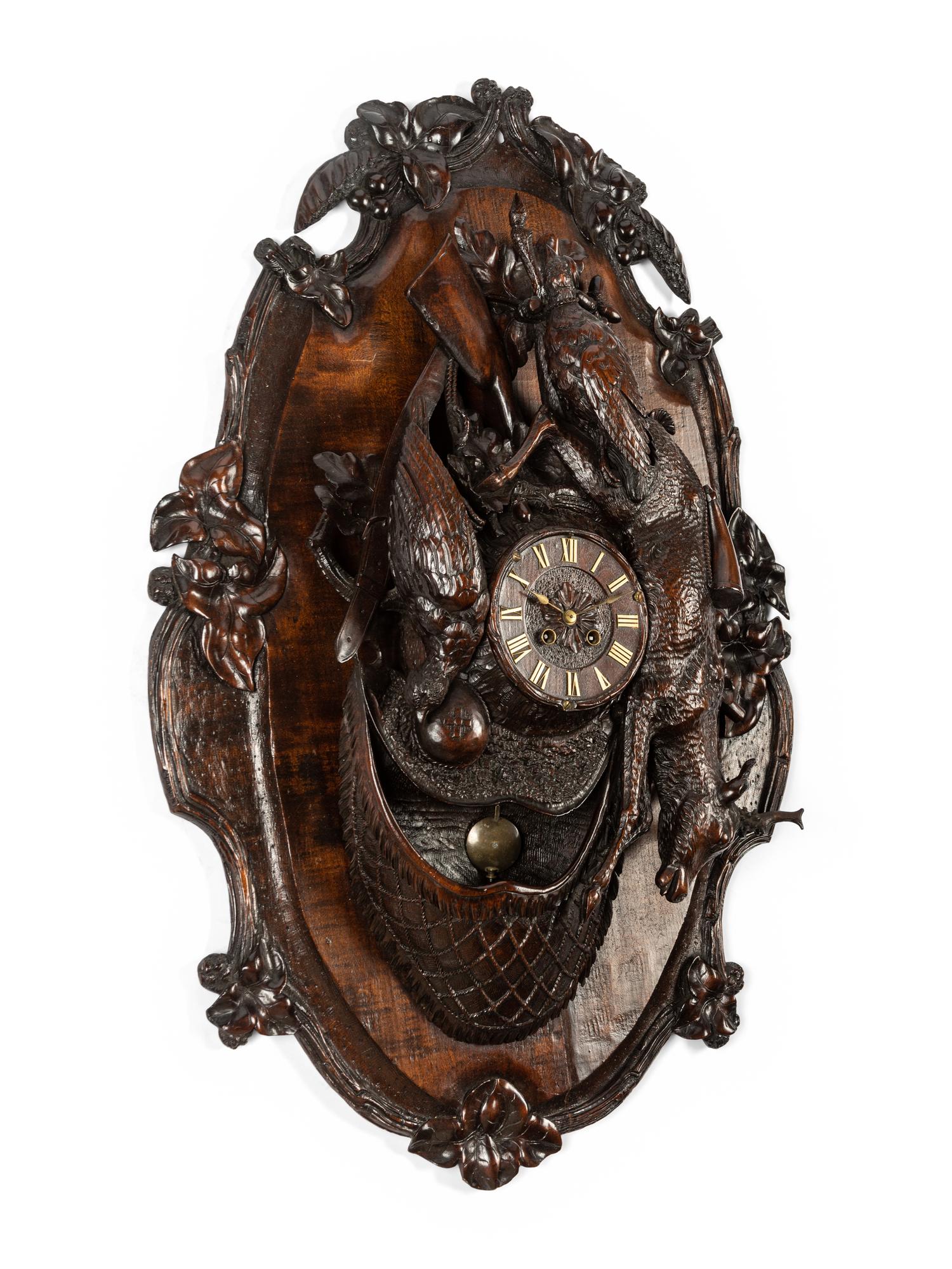 A Swiss Black Forest Carved Walnut Clock