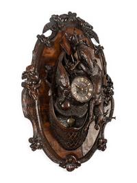 A Swiss Black Forest Carved Walnut Clock