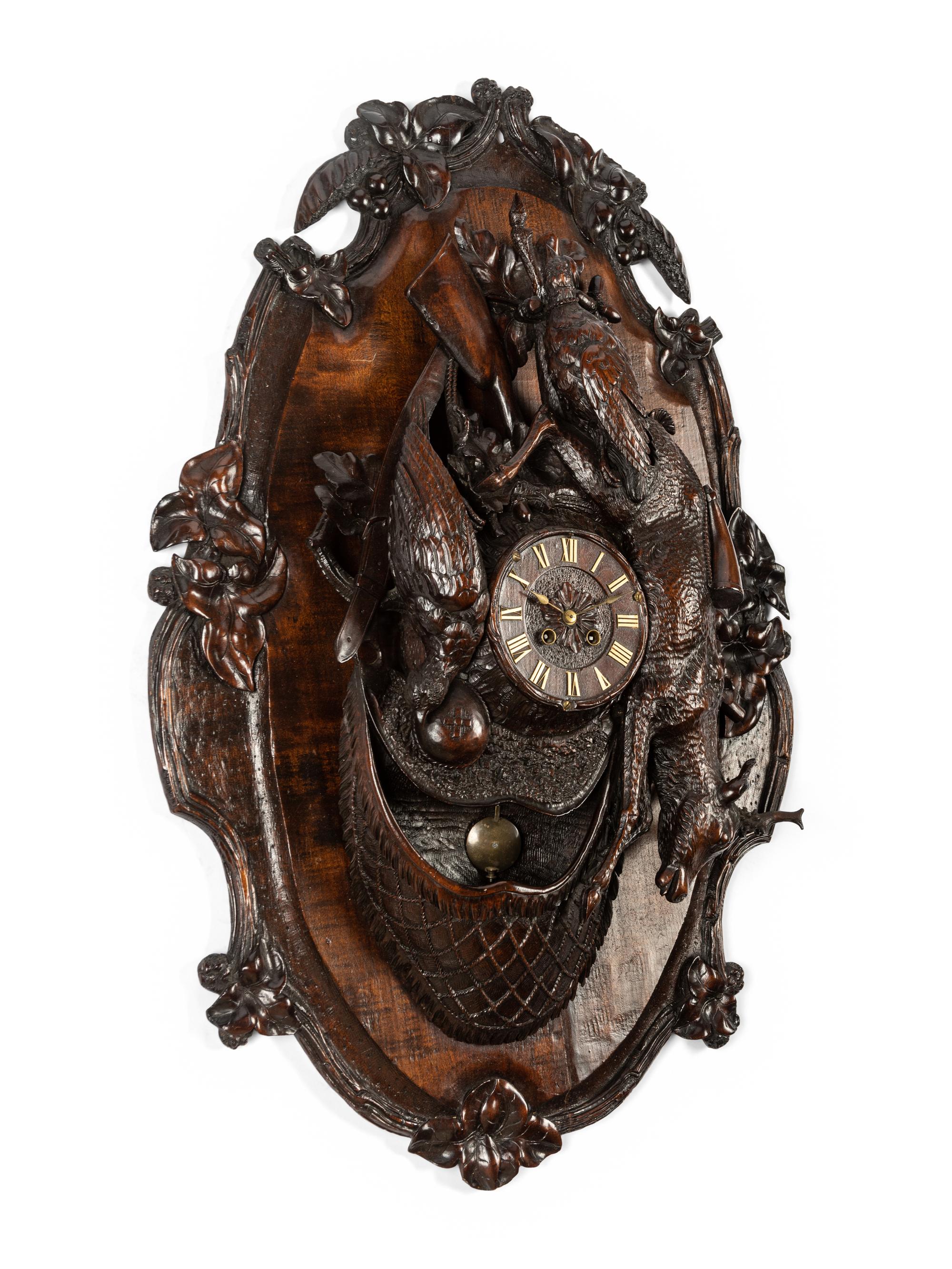A Swiss Black Forest Carved Walnut Clock