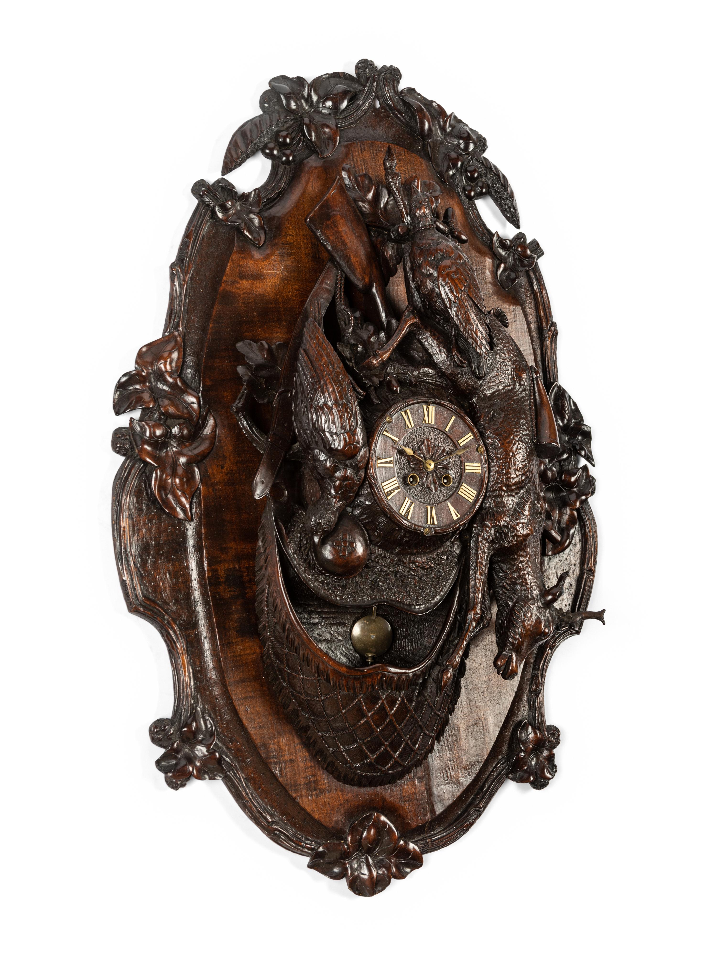 A Swiss Black Forest Carved Walnut Clock