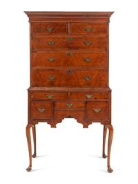 A Queen Anne Figured and Veneered Walnut Flat-Top High Chest Of Drawers