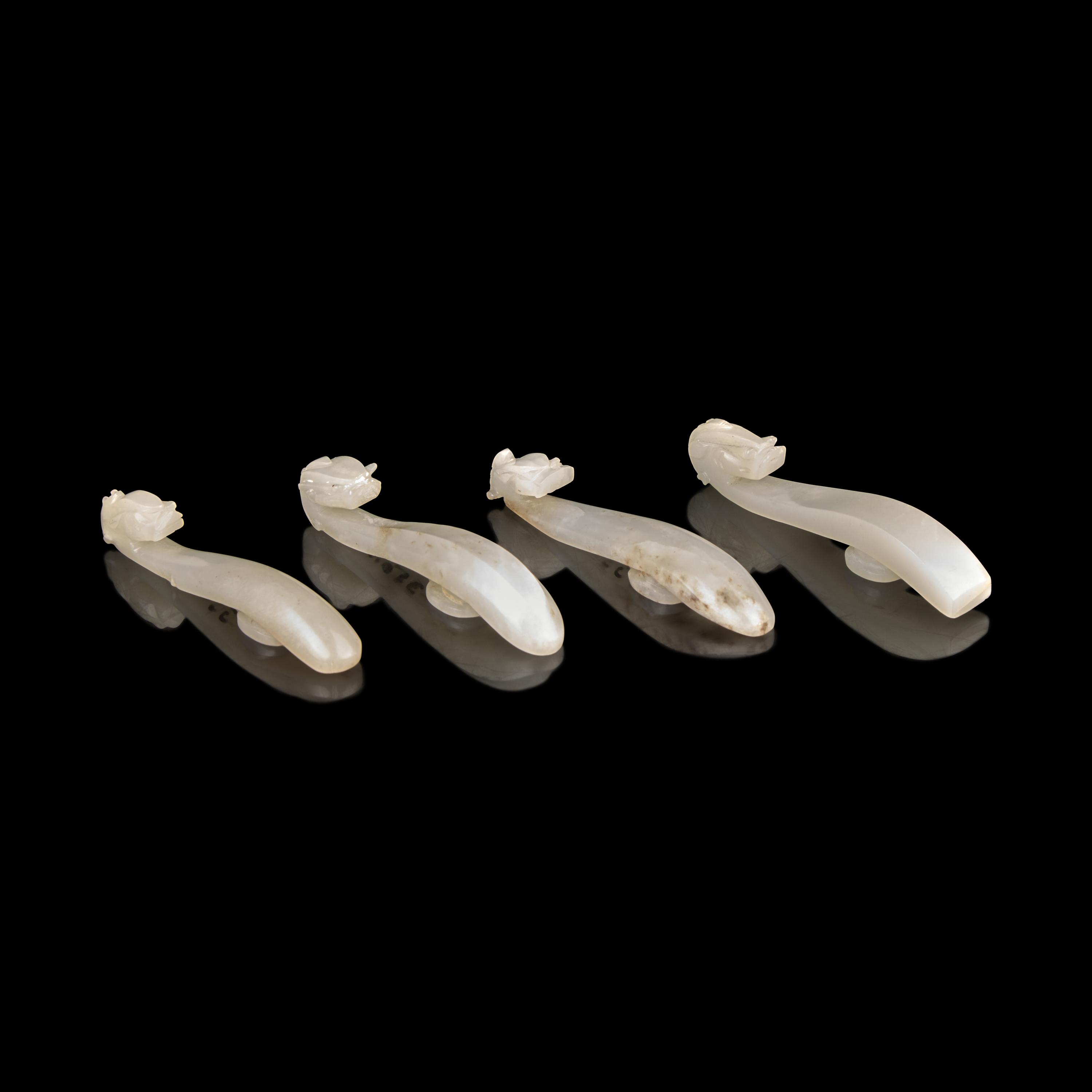Four Chinese Greyish White Jade "Dragon" Head Belt Hooks, Qing Dynasty — 清 灰白玉龍鉤四件