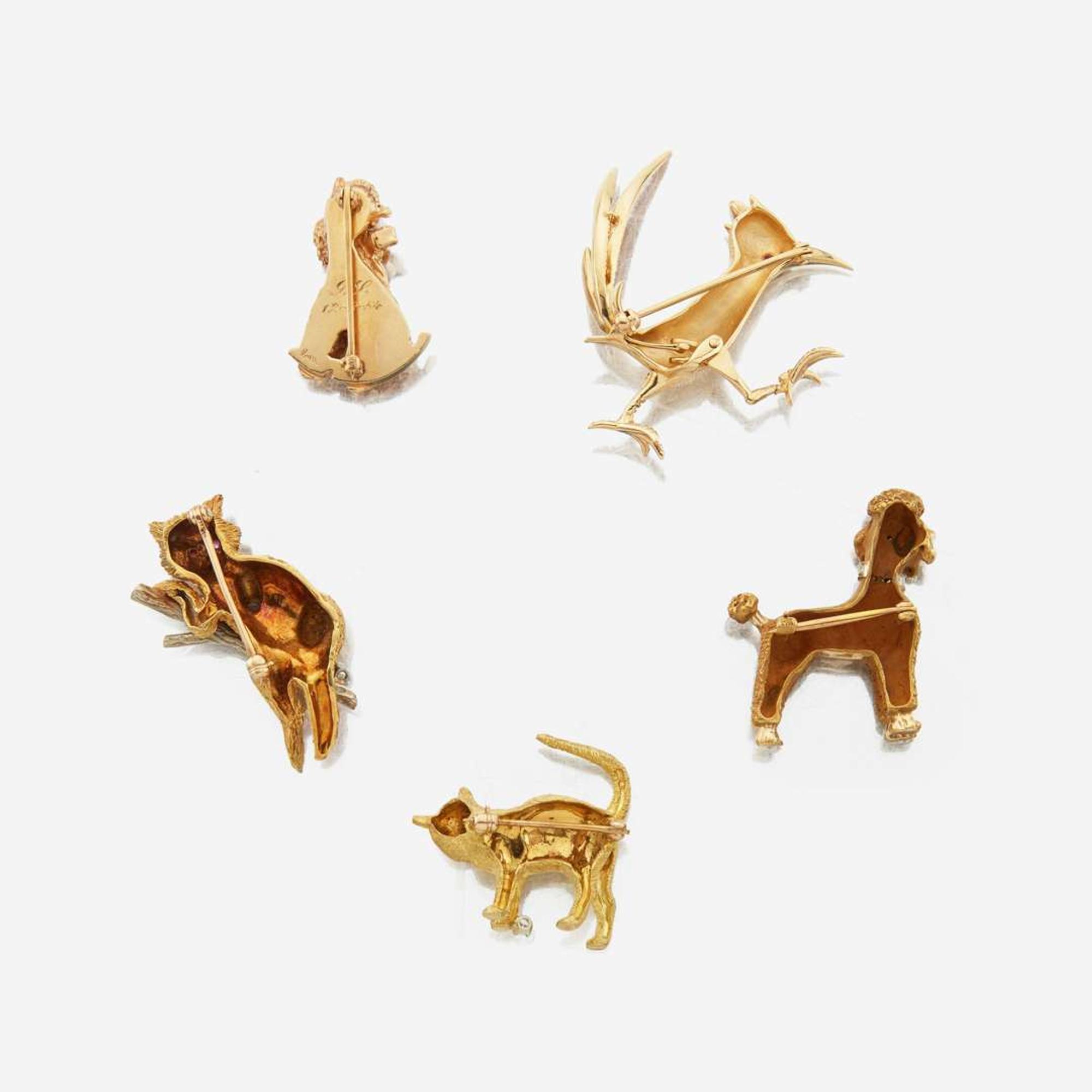 A collection of five gold and gem-set brooches